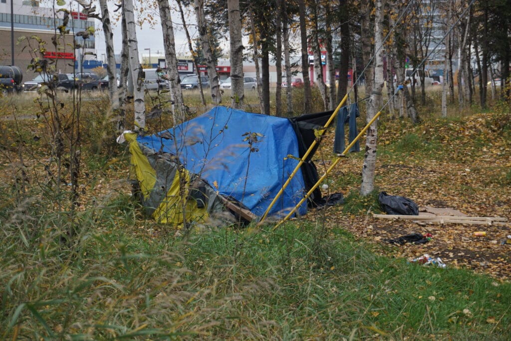 A campsite is seen in Anchorage, Alaska, last year. The Trump administration has proposed a major shift in homelessness grants. (Photo by Yereth Rosen/Alaska Beacon)