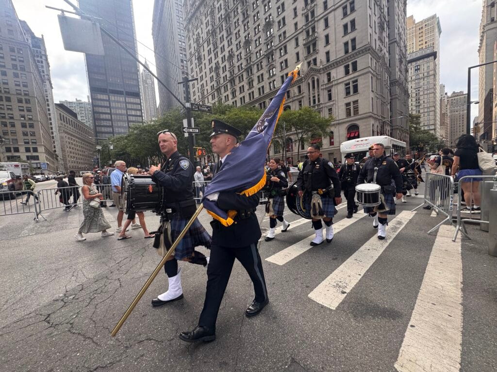 NYPD officers walk down a street in downtown Manhattan as part of the 25th anniversary of 9/11 memorial on Sept. 11, 2026. (Photo by Shalina Chatlani/ Stateline)