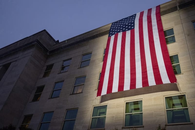 An American flag hangs down the side of the Pentagon, Sept. 11, 2026. The flag was unfurled during a sunrise ceremony to mark the 25th anniversary of 9/11. (Photo by Air Force Staff Sgt. Madelyn Keech/Department of Defense)