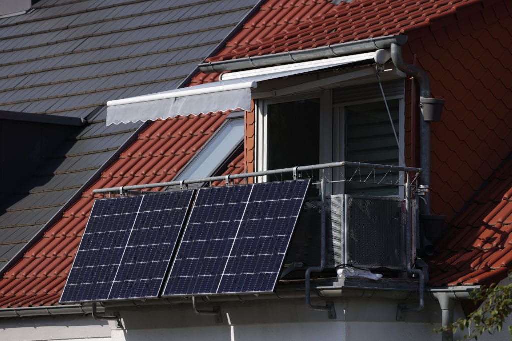Solar energy panels hang from a residential apartment balcony in Erfurt, Germany. Balcony solar systems have become popular in Germany, and some state lawmakers believe the technology has huge potential in the United States. (Photo by Sean Gallup/Getty Images)