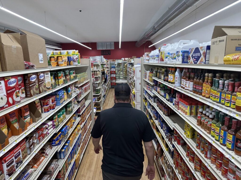 General Manager Brian Horak walks down an aisle at Post 60 Market in Emerson, Nebraska. A new national report shows how everyday costs have increased for Americans. (Photo by Kevin Hardy/Stateline)