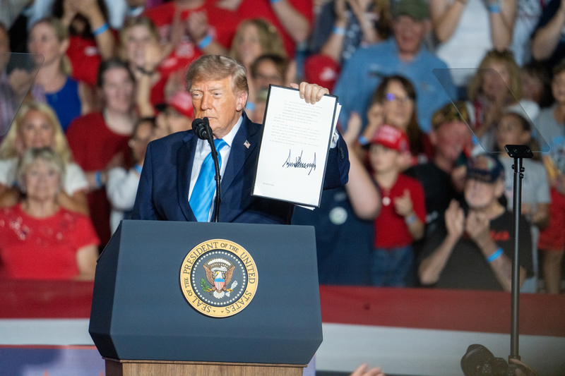 President Donald Trump holds up an executive order he just signed waiving federal taxes on red-dyed diesel during a 2026 midterms rally in Grand Island, Nebraska, on Oct. 5, 2026, at the Nebraska State Fairgrounds with thousands in attendance. (Photo by Zach Wendling/Nebraska Examiner)